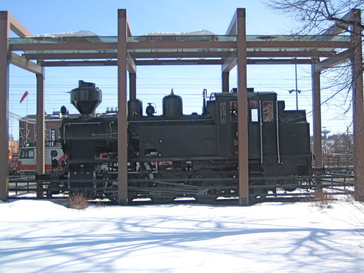 An old 0-8-0 Steamer sits under a glass roof near the staton at Jyväskylä