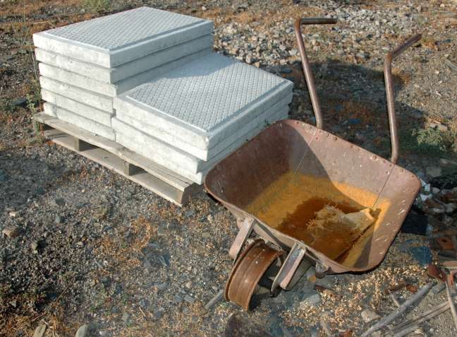 Offset-handled railway wheelbarrow and pile of concrete tiles, Pocinho, along the Douro River, Portugal